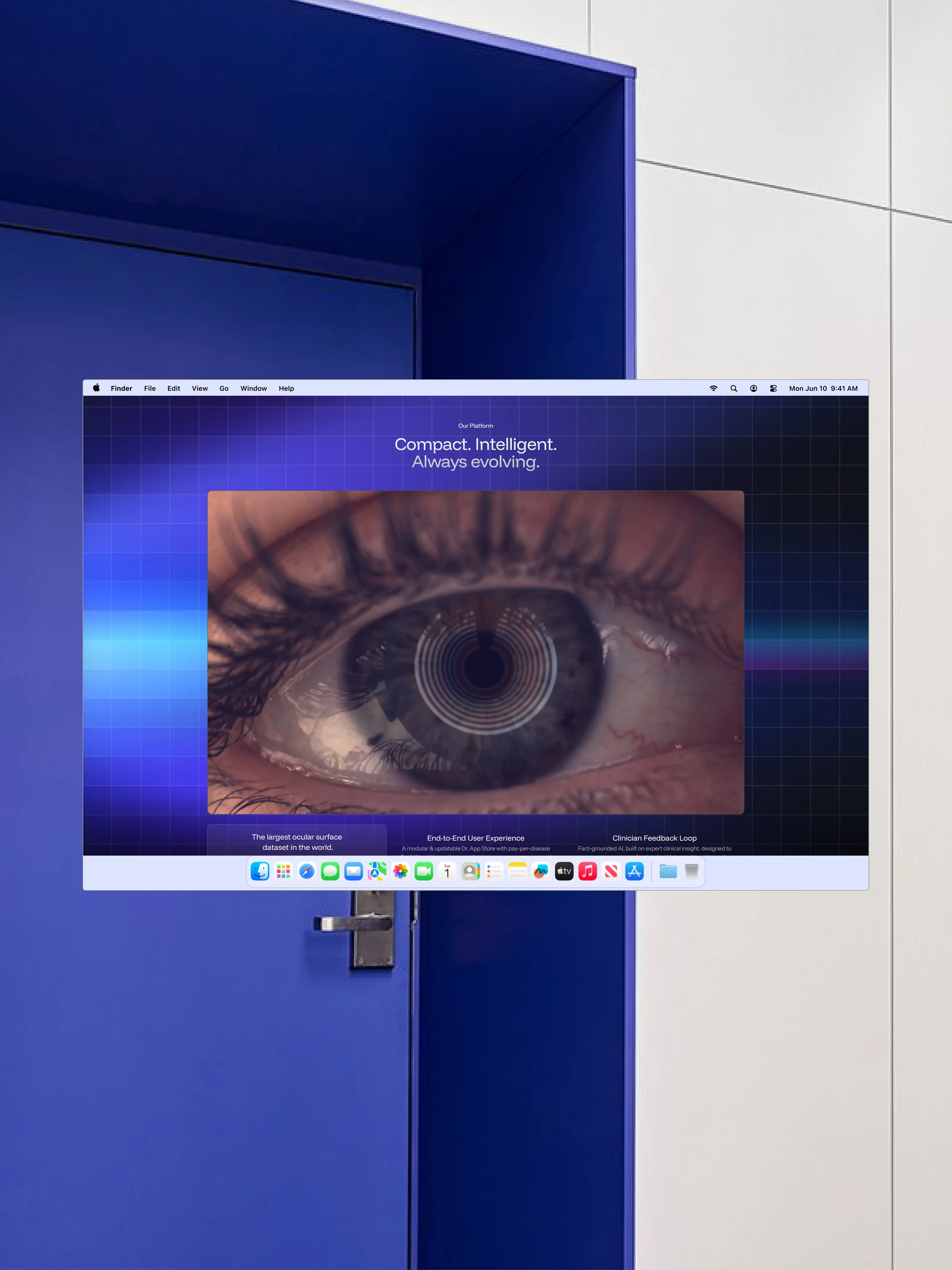 Close-up of a human eye with a digital circular pattern overlay on the iris, displayed on a computer screen with a blue grid background and the text 'Compact. Intelligent. Always evolving.'