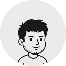 Black and white cartoon avatar of a man with short hair and slight stubble in a round frame.