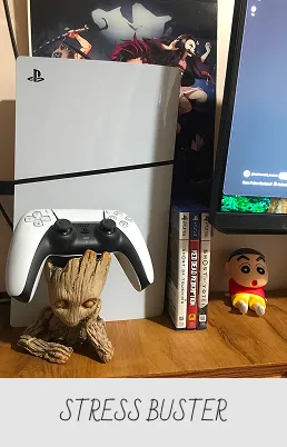 PlayStation 5 console and controller displayed on a wooden surface with a Groot figurine holding the controller, next to three PS5 game cases and a small cartoon character figurine.
